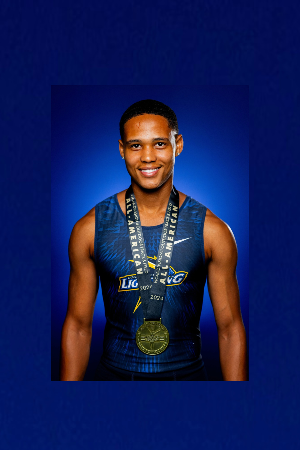Ashwin Jood smiling in his athletics uniform with medals
